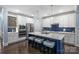 Modern kitchen with white cabinets, stainless steel appliances, island with barstools, and ample counter space at 2625 Rea Pond Ct, Charlotte, NC 28226