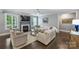 Cozy living room with dark hardwood floors, a fireplace, and natural light at 2625 Rea Pond Ct, Charlotte, NC 28226