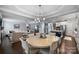 Open concept living and dining area with dark hardwood floors and modern lighting at 2625 Rea Pond Ct, Charlotte, NC 28226