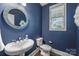 Stylish powder room features a pedestal sink, round mirror, and modern fixtures at 2625 Rea Pond Ct, Charlotte, NC 28226