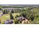 Expansive aerial view of the property with golf course and lake views, surrounded by lush trees and well-manicured lawns at 277 Tradition Dr, Mount Gilead, NC 27306
