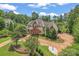 Stunning aerial view of an estate surrounded by lush greenery, showcasing its expansive grounds and prime location at 277 Tradition Dr, Mount Gilead, NC 27306