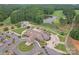 Beautiful aerial view of the clubhouse, golf course, pond, and parking lot, surrounded by lush greenery at 277 Tradition Dr, Mount Gilead, NC 27306
