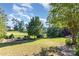 Expansive backyard featuring lush greenery and golf course views, perfect for outdoor activities at 277 Tradition Dr, Mount Gilead, NC 27306