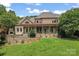 A landscaped backyard, complete with outdoor kitchen and covered porch at 277 Tradition Dr, Mount Gilead, NC 27306