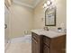 Bathroom featuring a walk-in shower, a vanity with decorative mirror, and travertine flooring at 277 Tradition Dr, Mount Gilead, NC 27306