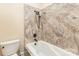 Bathroom with patterned tile shower with shower head and white bathtub at 277 Tradition Dr, Mount Gilead, NC 27306