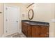 Bathroom vanity with granite countertops, wood cabinets and framed mirror at 277 Tradition Dr, Mount Gilead, NC 27306