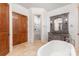 Elegant bathroom with a soaking tub, glass-enclosed shower, designer vanity, and sophisticated fixtures at 277 Tradition Dr, Mount Gilead, NC 27306