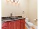 Rustic half-bath featuring a distinctive vessel sink, dark granite countertop, and stylish fixtures and hardware at 277 Tradition Dr, Mount Gilead, NC 27306