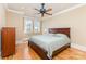 Bedroom with light yellow walls, a ceiling fan, and light hardwood floors at 277 Tradition Dr, Mount Gilead, NC 27306