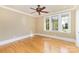 Bright, empty bedroom featuring pristine hardwood floors, multiple windows, and neutral wall colors at 277 Tradition Dr, Mount Gilead, NC 27306