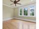Well-lit bedroom boasts hardwood floors, crown molding, trim, and a ceiling fan at 277 Tradition Dr, Mount Gilead, NC 27306