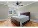 Relaxing bedroom with hardwood floors, ceiling fan, and natural light at 277 Tradition Dr, Mount Gilead, NC 27306