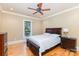 Comfortable bedroom with hardwood floors, a ceiling fan, and a large window offering natural light at 277 Tradition Dr, Mount Gilead, NC 27306