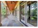 Expansive covered porch with stone flooring and multiple seating areas at 277 Tradition Dr, Mount Gilead, NC 27306