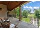 Inviting covered porch offering scenic views of the lush green lawn and golf course at 277 Tradition Dr, Mount Gilead, NC 27306