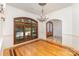 Formal dining room featuring a large window, hardwood floors with decorative border, and elegant chandelier at 277 Tradition Dr, Mount Gilead, NC 27306
