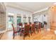 Dining area with hardwood floors, brick archway, and multiple windows at 277 Tradition Dr, Mount Gilead, NC 27306