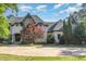 Charming home featuring a stone and stucco facade, elegant architectural details, and a well-manicured front yard at 277 Tradition Dr, Mount Gilead, NC 27306