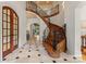 Elegant foyer with curved staircase, iron railings, and marble floors at 277 Tradition Dr, Mount Gilead, NC 27306