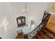 Elegant foyer with a wrought iron staircase, hardwood floors, chandelier, and a decorative front door at 277 Tradition Dr, Mount Gilead, NC 27306