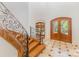 Elegant foyer featuring a curved wooden staircase with iron railings and marble floors with black accents at 277 Tradition Dr, Mount Gilead, NC 27306