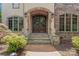 Inviting front entrance with stone archway, double doors, and lion statues, creating a grand arrival at 277 Tradition Dr, Mount Gilead, NC 27306