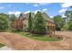 Elegant home featuring a circular driveway and manicured landscaping at 277 Tradition Dr, Mount Gilead, NC 27306