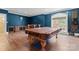 Elegant game room with pool table, hardwood floors, and window with natural light at 277 Tradition Dr, Mount Gilead, NC 27306