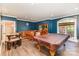 Basement game room with a pool table, chess table, bar area, blue walls, and wood floors at 277 Tradition Dr, Mount Gilead, NC 27306