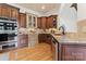 Well-appointed kitchen featuring custom cabinetry, granite countertops, and stainless steel appliances at 277 Tradition Dr, Mount Gilead, NC 27306