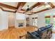Bright living room with hardwood floors, a stone fireplace, and French doors leading to an outdoor space at 277 Tradition Dr, Mount Gilead, NC 27306