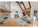 Bright living room featuring a stone fireplace, vaulted ceiling with wooden beams, and an open layout at 277 Tradition Dr, Mount Gilead, NC 27306