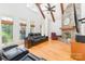 Living room with stone fireplace, wood floors, and beamed ceiling at 277 Tradition Dr, Mount Gilead, NC 27306