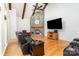 Living room featuring stone fireplace, wood floors, vaulted ceiling, and natural light at 277 Tradition Dr, Mount Gilead, NC 27306