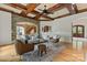 Open-concept living room featuring a brick archway, hardwood floors, and comfortable seating at 277 Tradition Dr, Mount Gilead, NC 27306