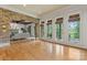 Bright and spacious living room with hardwood floors, large windows, and a brick archway at 277 Tradition Dr, Mount Gilead, NC 27306