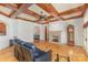 Spacious living room with hardwood floors, a stone fireplace, and a coffered ceiling with a ceiling fan at 277 Tradition Dr, Mount Gilead, NC 27306