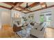 Cozy living room with a coffered ceiling, stone fireplace, and plenty of natural light at 277 Tradition Dr, Mount Gilead, NC 27306