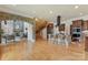 Open-concept living area featuring hardwood floors, stone fireplace, kitchen island with breakfast bar, and staircase at 277 Tradition Dr, Mount Gilead, NC 27306
