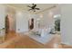 Spacious bedroom featuring hardwood floors, ample natural light, and access to a hallway with arched doorways at 277 Tradition Dr, Mount Gilead, NC 27306