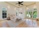 Serene bedroom with tray ceiling, hardwood floors, large windows offering natural light, and neutral decor at 277 Tradition Dr, Mount Gilead, NC 27306