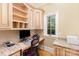 Cozy home office featuring custom built-ins, granite countertops, a modern computer setup, and a bright window view at 277 Tradition Dr, Mount Gilead, NC 27306
