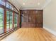 Office with hardwood floors, custom built-in shelving, large windows with outdoor views, and crown molding at 277 Tradition Dr, Mount Gilead, NC 27306