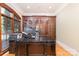 Executive office featuring dark wood built-in cabinetry, hardwood floors, and a sophisticated ambiance at 277 Tradition Dr, Mount Gilead, NC 27306