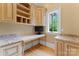 A home office with custom built in cabinets, desk space, granite countertops, and natural light at 277 Tradition Dr, Mount Gilead, NC 27306