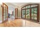 Office with French doors, hardwood flooring, a large arched window, and views of the landscaped yard at 277 Tradition Dr, Mount Gilead, NC 27306