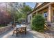 Charming outdoor patio boasts a stone fireplace, dining area, and beautifully landscaped surroundings at 277 Tradition Dr, Mount Gilead, NC 27306