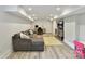 Bright basement features a gray couch, desk, and play area at 2804 Park Rd, Charlotte, NC 28209